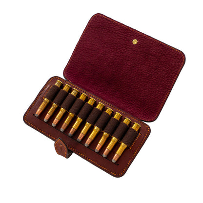 Handcrafted burgundy leather rifle cartridge wallet holding ten bullets with a secure flap and cufflink closure.