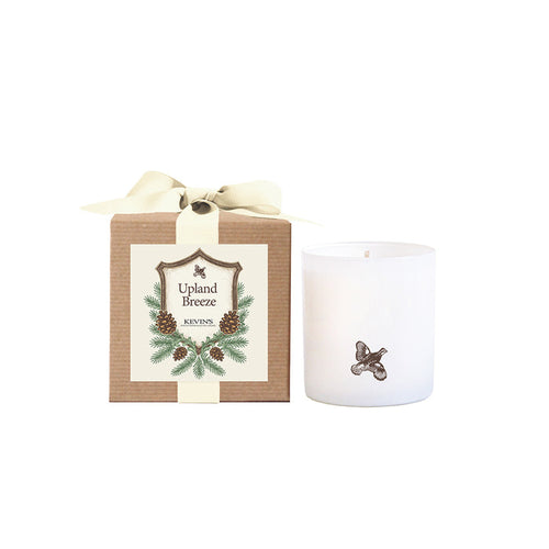 White soy candle with a bird logo next to a kraft gift box featuring a pinecone label and cream ribbon.