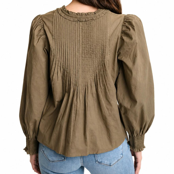 Olive green cotton cambric top with ruffled neckline, pleated back detailing, and long sleeves with smocked cuffs.