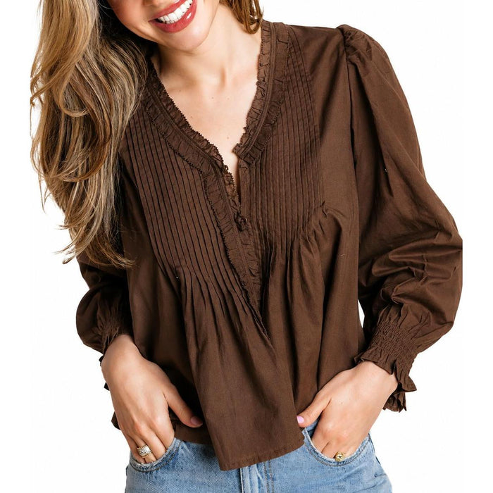Brown cotton cambric top with ruffled trim, pleated front detailing, and elasticized cuffs for a feminine silhouette.