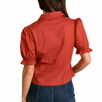 Rust-colored cotton cambric blouse with a collared neckline and ruffled short sleeves, shown from the back.
