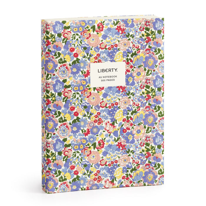 The Liberty London Nell, Annie and May Premium A5 Notebook is a hardcover A5 notebook with a vibrant red, blue, yellow, and green floral pattern and a white label reading “LIBERTY. A5 NOTEBOOK 300 PAGES.”.