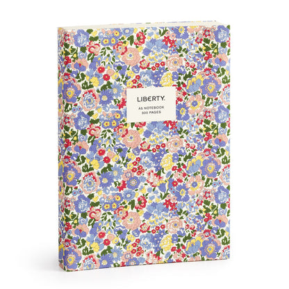 The Liberty London Nell, Annie and May Premium A5 Notebook is a hardcover A5 notebook with a vibrant red, blue, yellow, and green floral pattern and a white label reading “LIBERTY. A5 NOTEBOOK 300 PAGES.”.