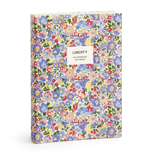 The Liberty London Nell, Annie and May Premium A5 Notebook is a hardcover A5 notebook with a vibrant red, blue, yellow, and green floral pattern and a white label reading “LIBERTY. A5 NOTEBOOK 300 PAGES.”.