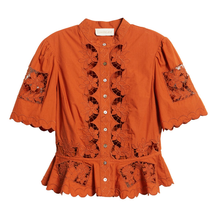 Cinnamon-colored peplum top with floral cutwork lace, short puff sleeves, high neckline, and button-down front.