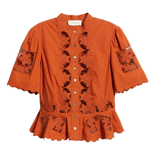 Cinnamon-colored peplum top with floral cutwork lace, short puff sleeves, high neckline, and button-down front.