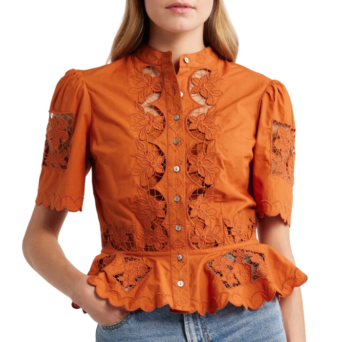 Cinnamon-colored peplum top with floral cutwork lace, short puff sleeves, high neckline, and button-down front.