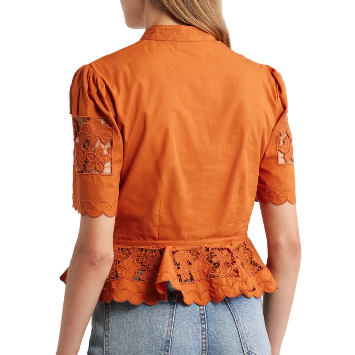 Cinnamon-colored peplum top with puff sleeves and intricate floral cutwork lace detailing on the hem and sleeves.
