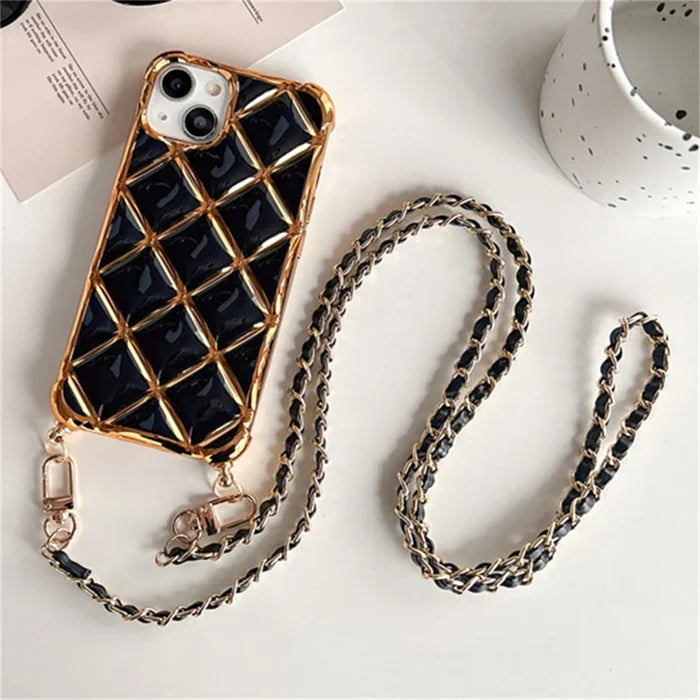 Black quilted phone case with gold chain strap.