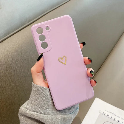 Light purple phone case with a gold heart design.