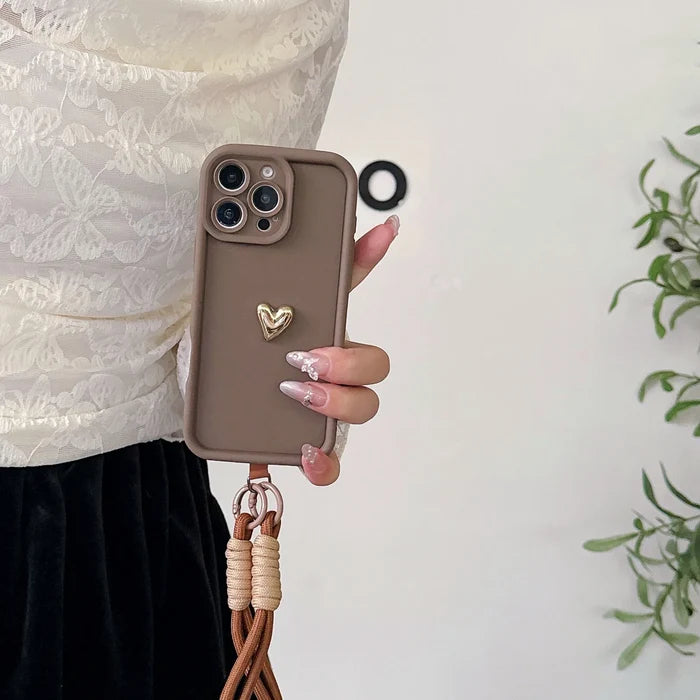 Brown phone case with heart charm and lanyard.