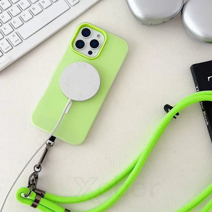 Lime green iPhone with MagSafe charger and lanyard.