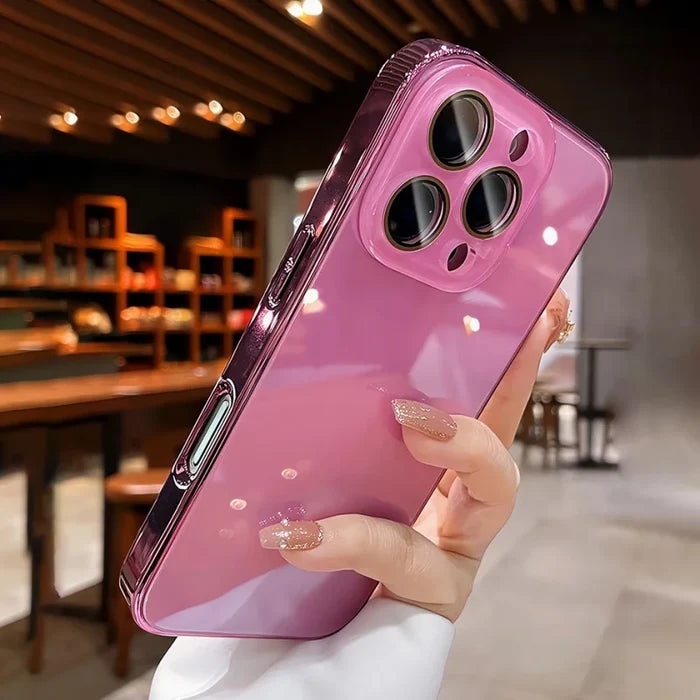 Hand holding a shiny pink phone case with a transparent camera module.