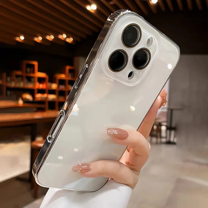 A hand holding a white iPhone with a clear and silver-edged case.