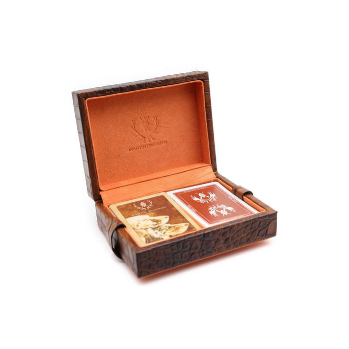 Brown alligator grain leather playing card case by Martin Dingman with a vibrant orange interior and two decks of cards.