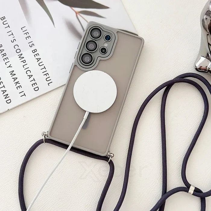 Smartphone in gray case with lanyard and wireless charger.