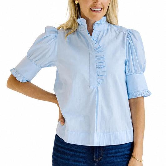 Light blue cotton poplin top with puff sleeves, a ruffled stand collar, and a button placket.