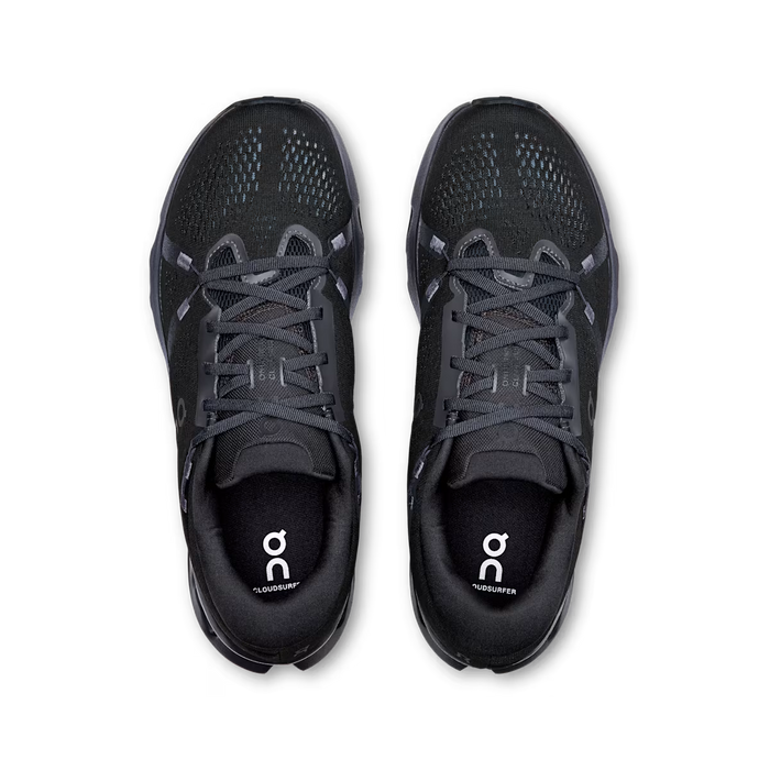 Top-down view of black On Running Cloudsurfer 2 men's sneakers with breathable mesh uppers and cushioned midsoles.