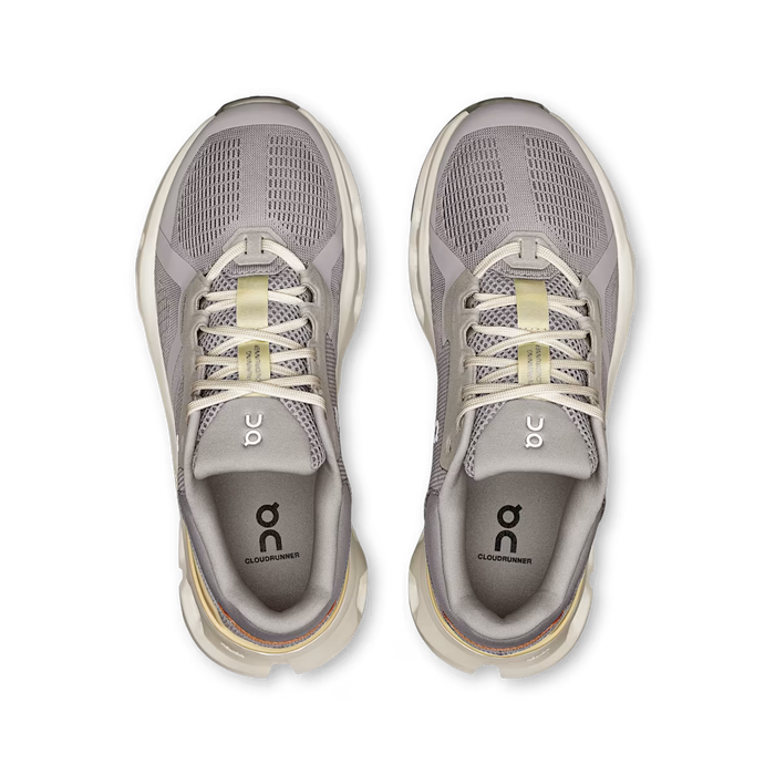 Top view of grey On Running Women's Cloudrunner 2 shoes featuring breathable mesh, cushioned midsoles, and lace-up design.