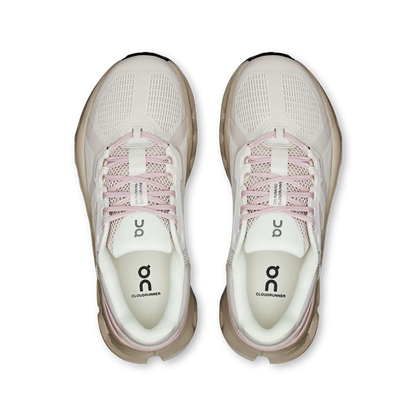 Top-down view of beige On Running Cloudrunner 2 women's shoes with pink laces and cushioned Helion foam midsoles.