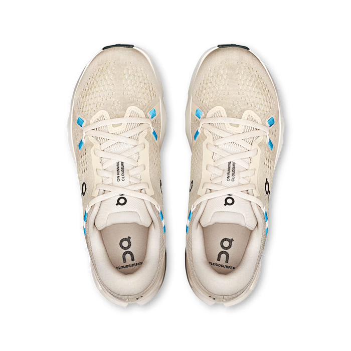 Top-down view of beige On Running Cloudsurfer 2 women's shoes with breathable mesh and bright blue eyelet accents.
