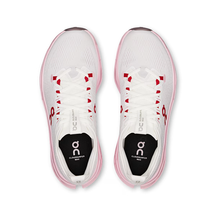 Top view of white On Running Cloudsurfer Max women's shoes with pink soles and red lace eyelet accents.