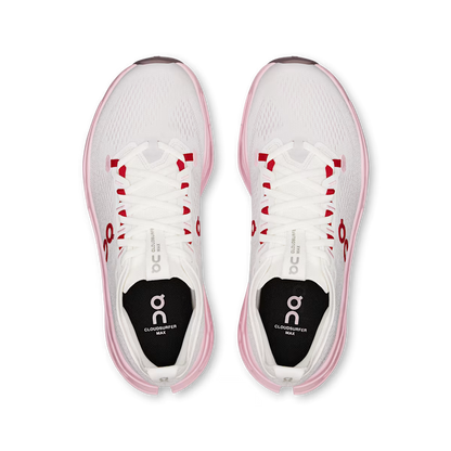 Top view of white On Running Cloudsurfer Max women's shoes with pink soles and red lace eyelet accents.