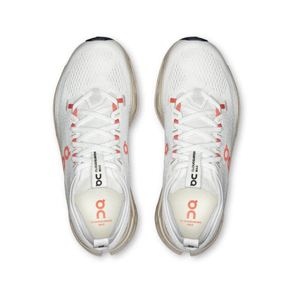 Top view of white On Running Cloudsurfer Max women's shoes with coral accents and a breathable mesh upper.