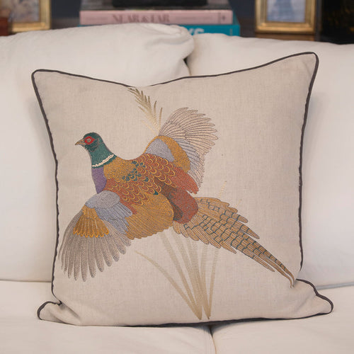 22-inch beige linen pillow cover featuring an intricate, colorful embroidered pheasant design with dark cording trim.