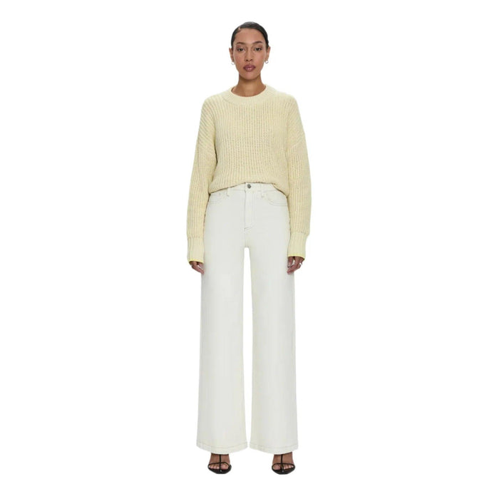 Pistola Lana high-rise ultra wide leg jeans in ecru denim with contrast stitching paired with a yellow knit sweater.