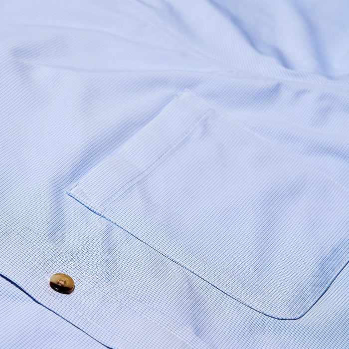 Light blue micro-check performance shirt featuring a single chest pocket and a dark button detail.