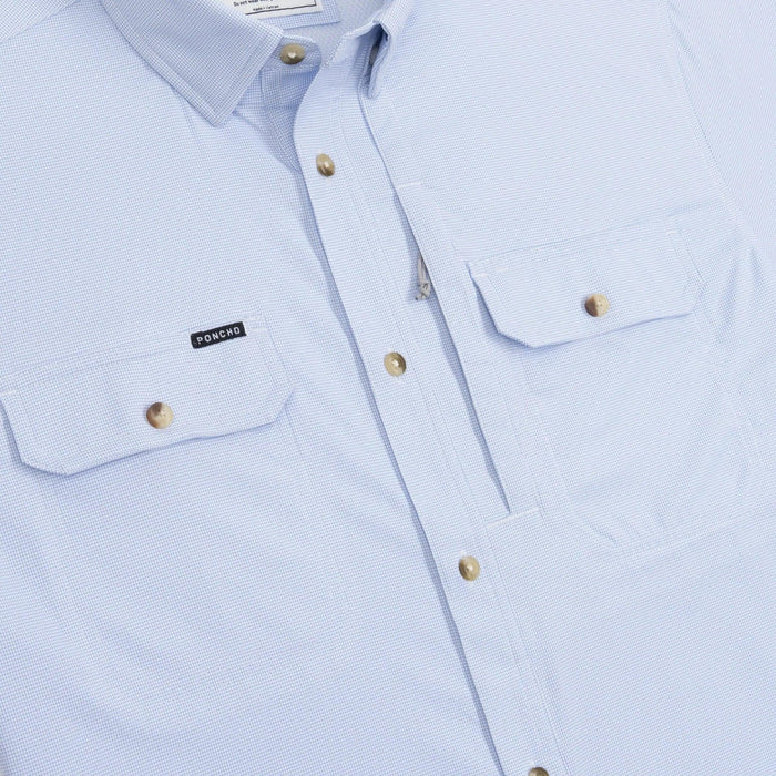 Light blue long-sleeve outdoor shirt with button-down collar, dual chest pockets, and Poncho logo patch.