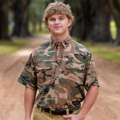 Man wearing a short-sleeve camouflage Cordoba outdoor shirt with button-down front and dual chest pockets.