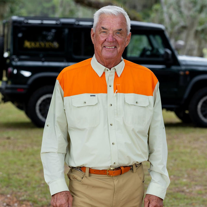 Man wearing a tan and orange long-sleeve Tuff-Thread performance shirt with dual chest pockets and a button-down collar.