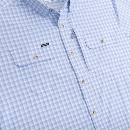 Light blue and white gingham performance shirt with two chest pockets, button-down collar, and Poncho brand logo.