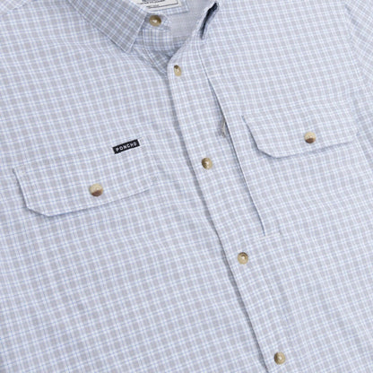 Light blue and white plaid short-sleeve performance shirt with button-down front and dual magnetic chest pockets.