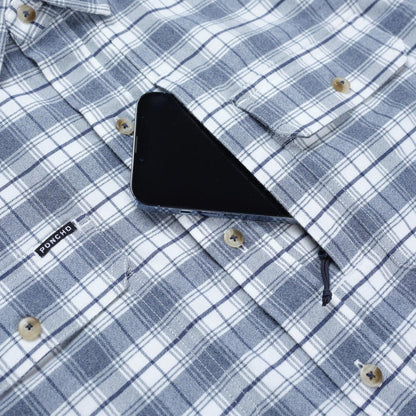 Blue and white plaid performance flannel shirt featuring a magnetic chest pocket holding a smartphone and a Poncho logo tag.
