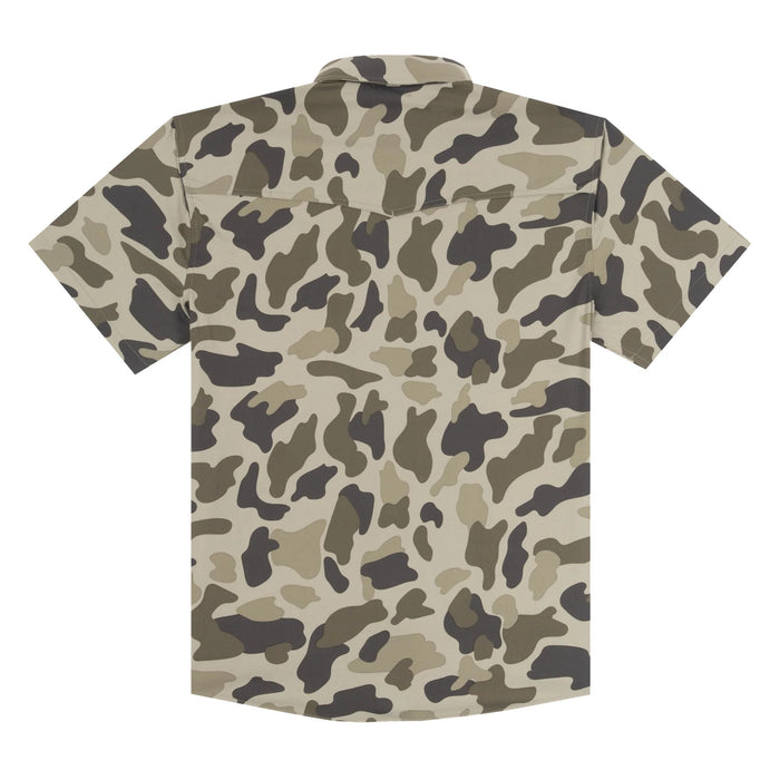 Short-sleeve button-up shirt with an all-over camouflage pattern in beige, brown, olive green, and dark gray, shown from the back on a plain white background.