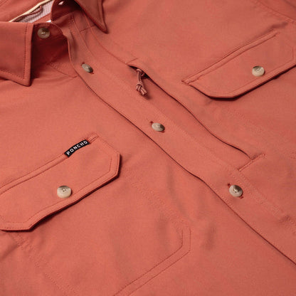 Terracotta-colored Poncho short sleeve performance shirt with button-down front, dual chest pockets, and sunglasses loop.