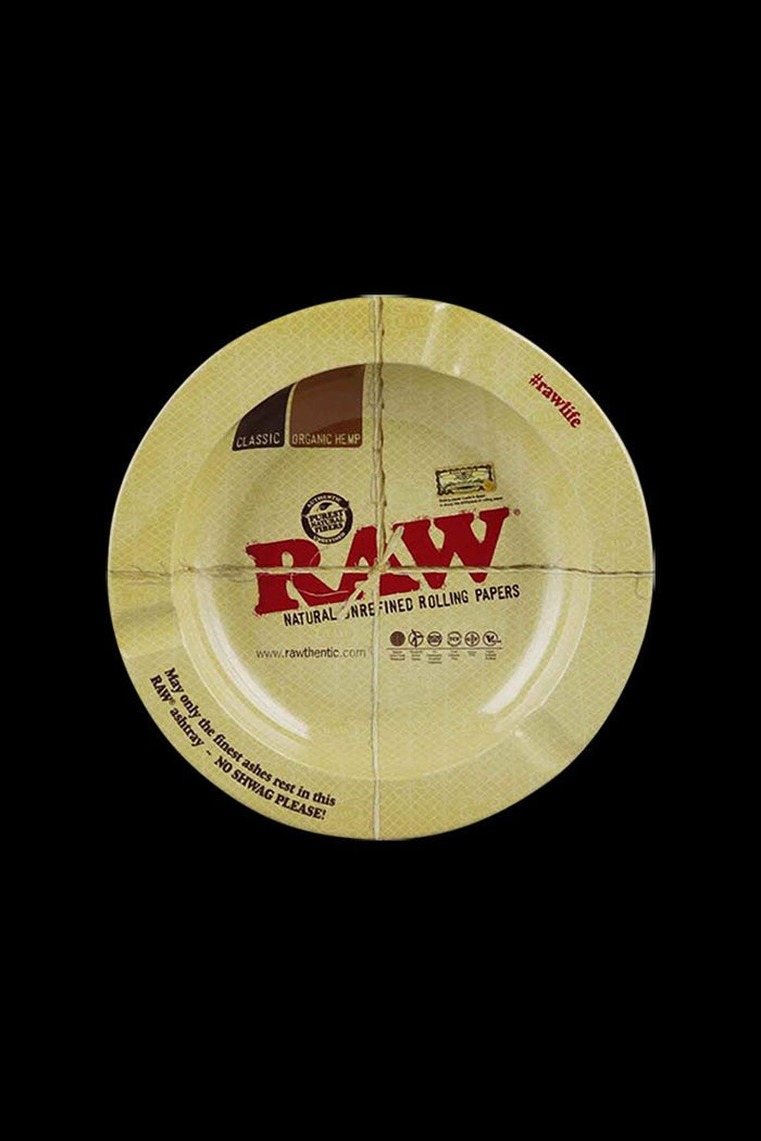 Overhead view of the RAW Round Metal Magnetic Ashtray, featuring circular branding and a textured, metallic surface.