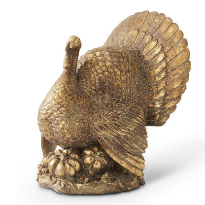 Antique gold resin turkey sculpture with intricate feather detailing and pumpkin accents for Thanksgiving decor.