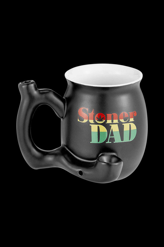 A close-up of the “Roast & Toast “Stoner Dad” Ceramic Pipe Mug” showcasing a black ceramic mug with a handle.