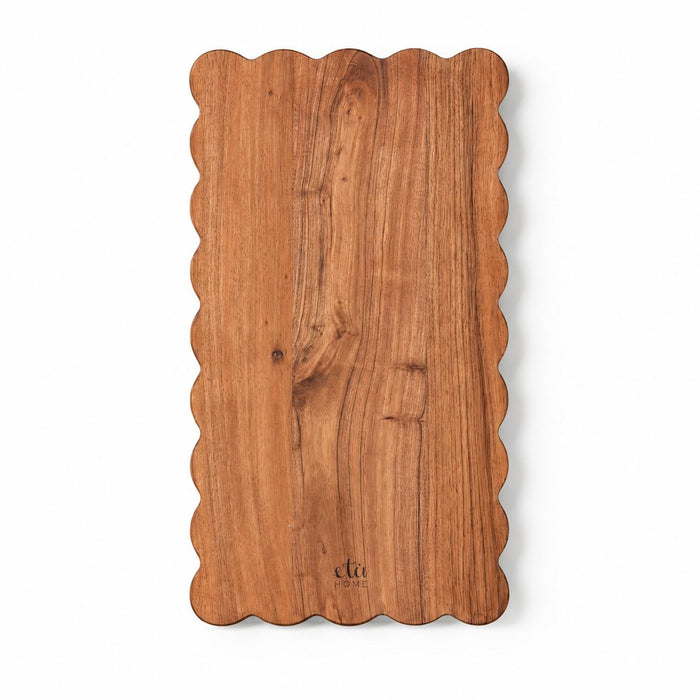 Rectangle acacia wood cutting board with elegant scalloped edges and visible natural wood grain.