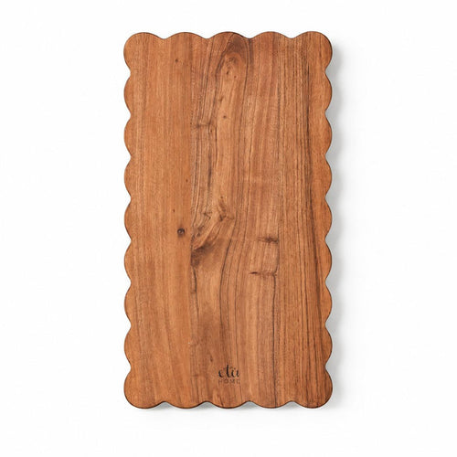 Rectangle acacia wood cutting board with elegant scalloped edges and visible natural wood grain.