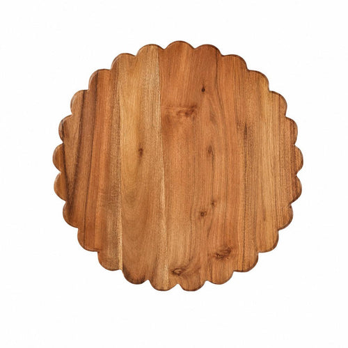 Round acacia wood cutting board with a decorative scalloped edge and natural wood grain finish.