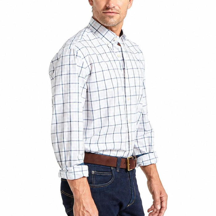 Man wearing a white and blue check Schoffel Holkham long-sleeve cotton twill shirt with branded buttons.