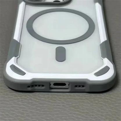 Clear smartphone case with reinforced gray and white corners, a circular MagSafe ring, and a bottom port opening.