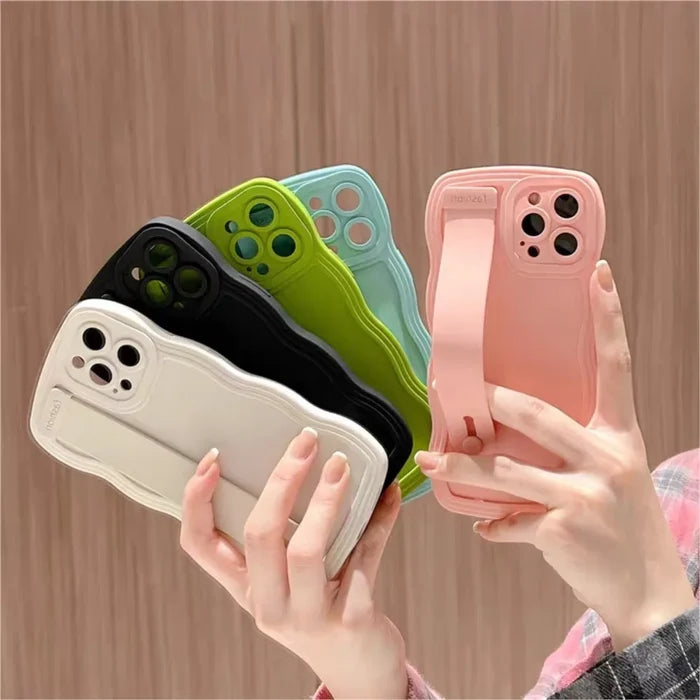 Colorful phone cases with hand straps.
