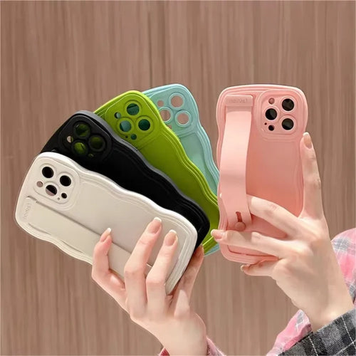 Colorful phone cases with hand straps.