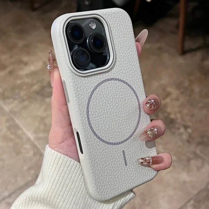 A hand holding a white textured iPhone case with a circular magnetic ring and a distinct camera cutout.